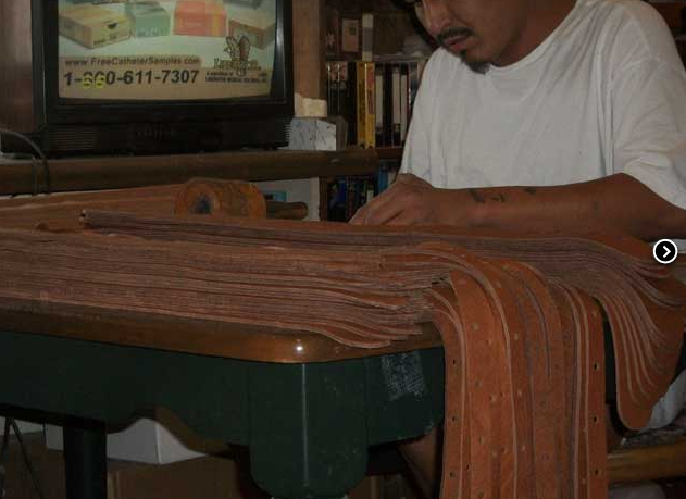 Lakota craftsman making bison leather banjo straps