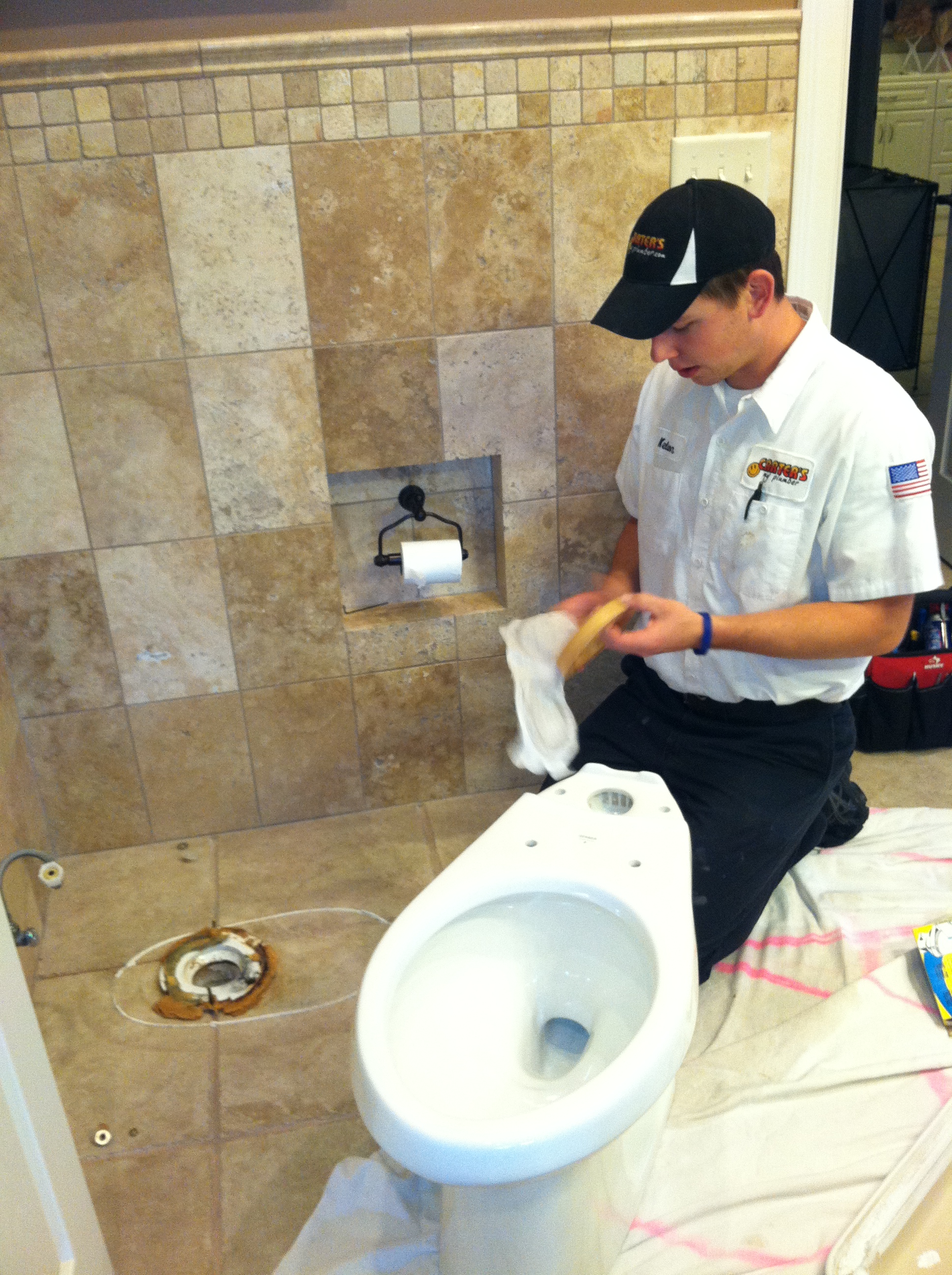 Kelson working on installing a new comfort height toilet