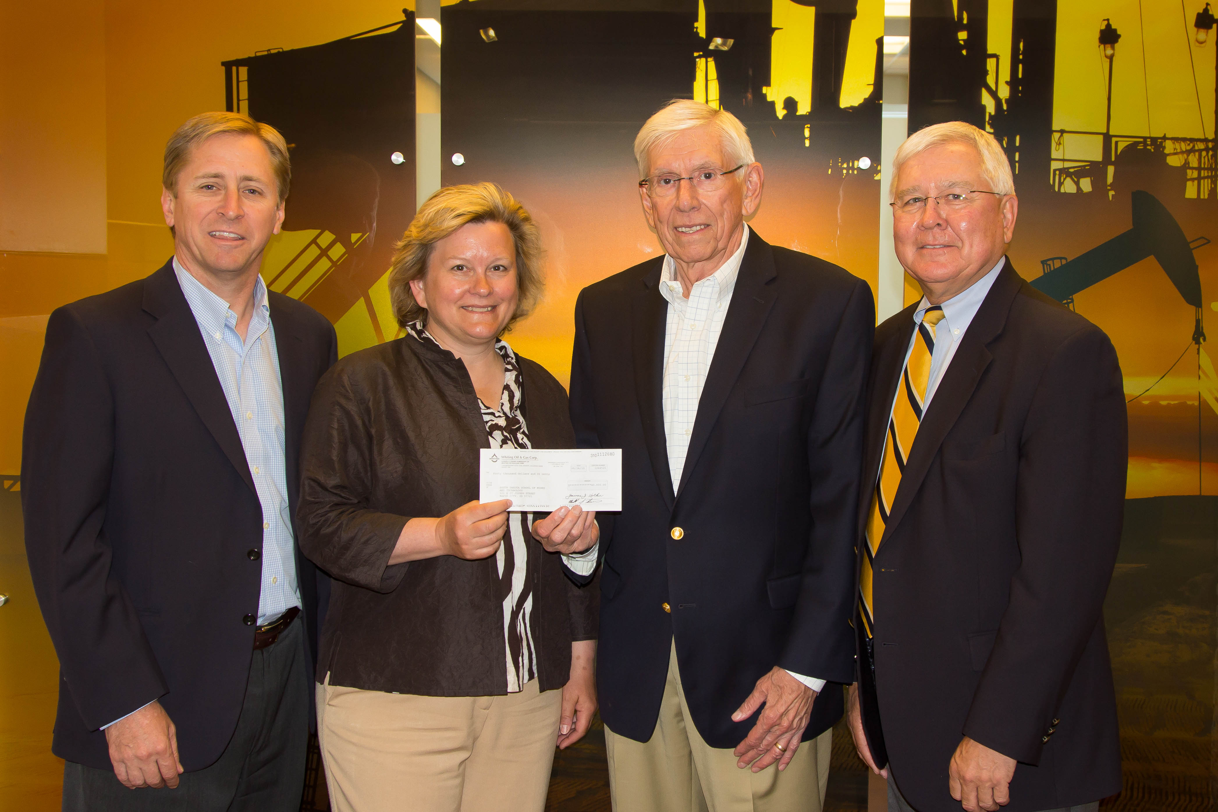 L to r: Rick Ross, Whiting vp of operations; Laurie Anderson, SDSM&T Department of Geology & Geological Engineering head; Sherwin Artus, Whiting director, former CEO; Ron Jeitz, SDSM&T Foundation.