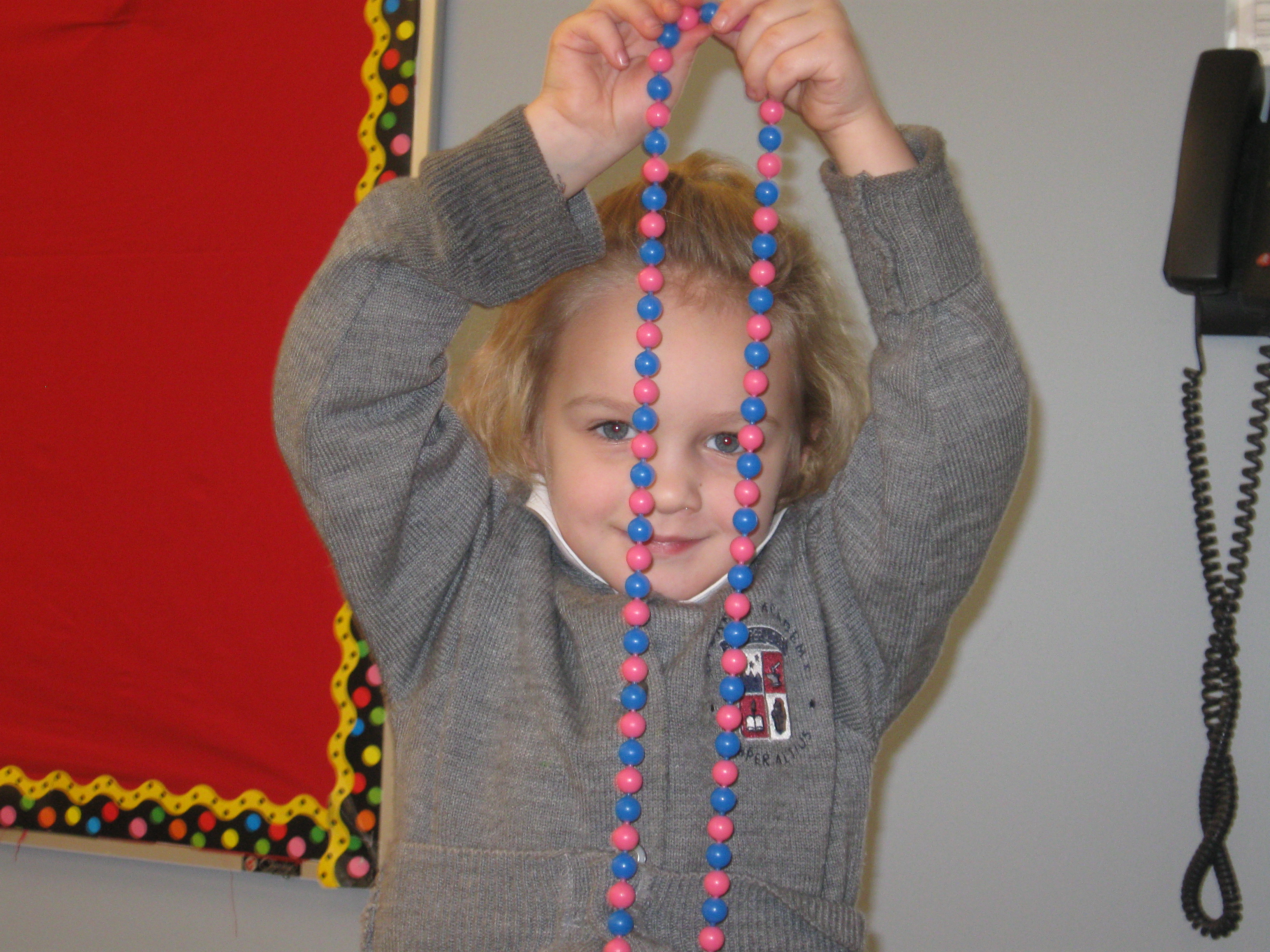 Lucia, daughter of Brad & Irene Lindow of Lemont, demonstrates her counting skills at Everest Academy Preschool