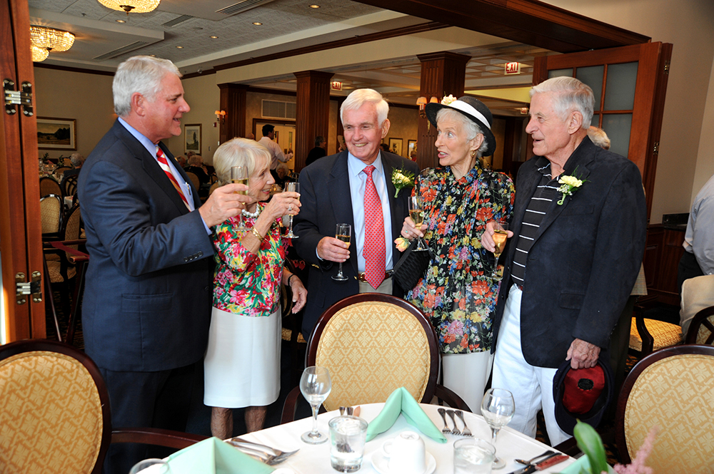 Todd Swortzel, president and CEO of Presbyterian Homes, raises a toast at the Lake Forest Place 15th Anniversary garden party with “pioneer” residents (R to L) Alice and Jack Bohlen and Hilda and Van