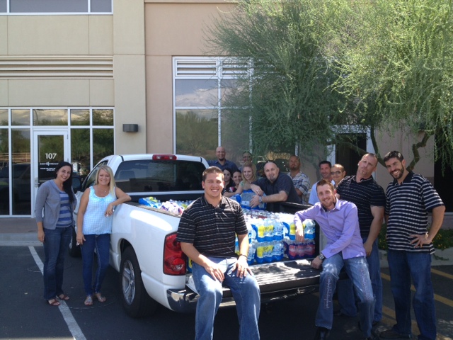 CPN USA employees pose with donated water for Hope On The Streets.