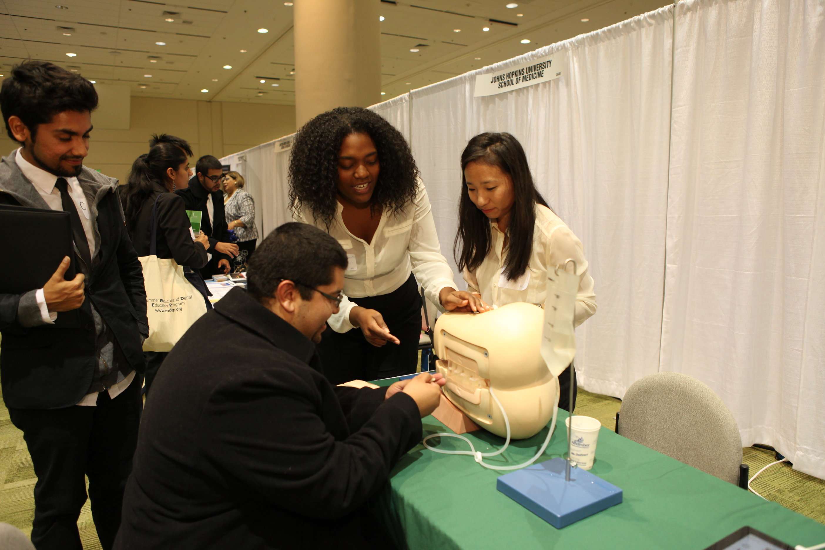Representatives from Geisel School of Medicine at Dartmouth University show students how to use a lumbar puncture and 3-D muscle I-Pad.