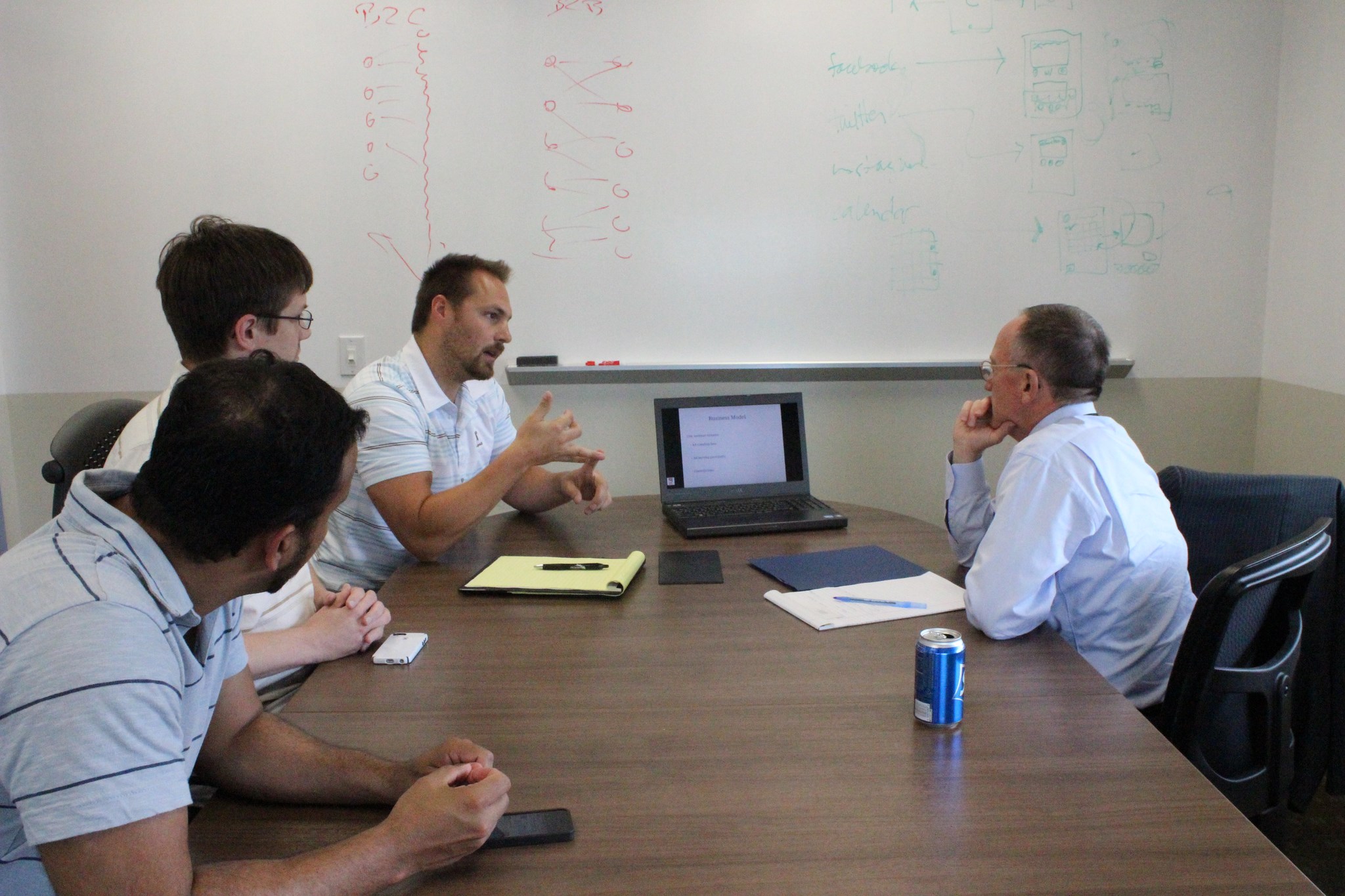 From left to right: Cympel founders Juliano Dasilva, Courtland Caldwel and Jesse Hultgren speak with Straight Shot mentor Mike McCarthy, founding partner of McCarthy Capital