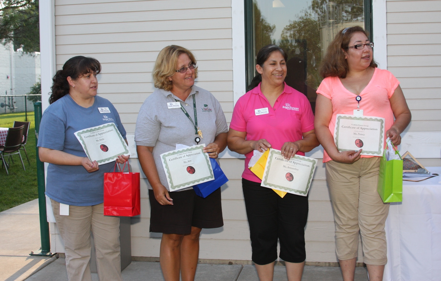 Four teachers, (l-r) Deila Garcia, Ann Lamb, Armandina Covarrubias and Nancy Longoria receive certificates of recognition for their commitment to the Vita Kids Learning Center.