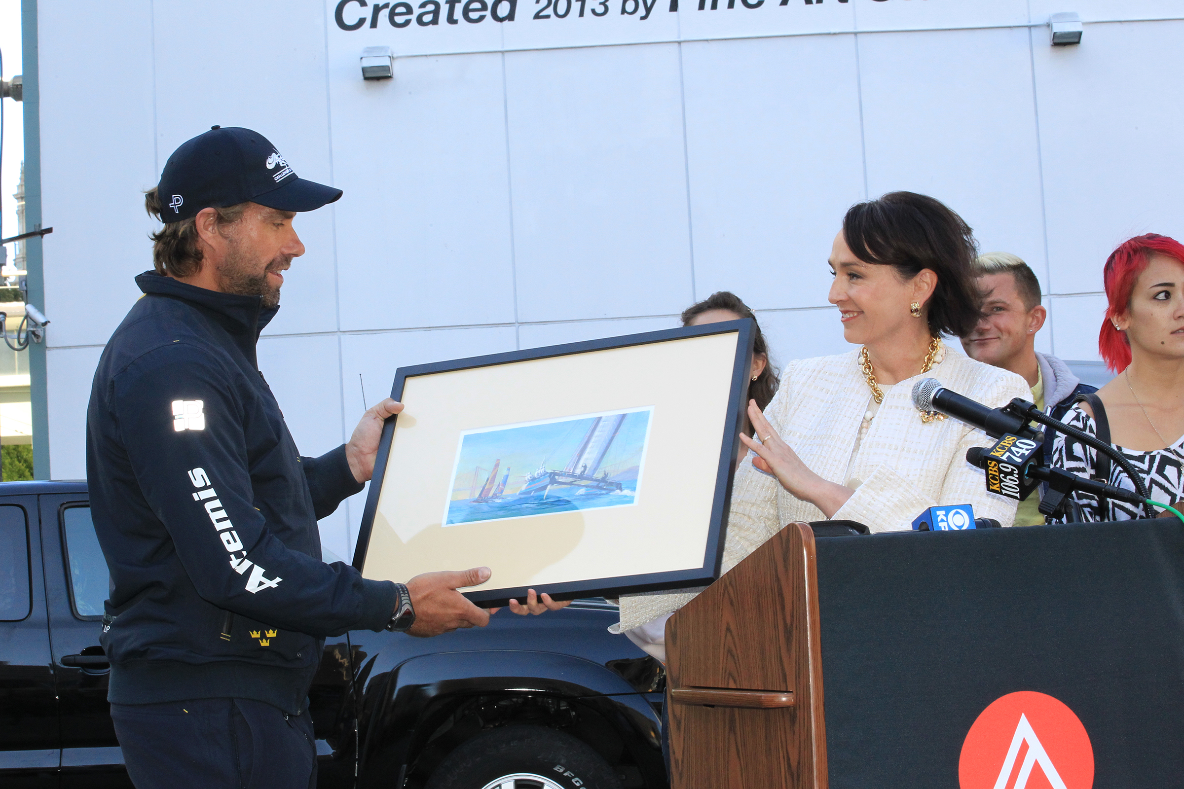 Dr. Elisa Stephens, President of the Academy of Art University, presenting Iain Percy, Skipper & Tactician of the Artemis Racing Team a smaller version of the America’s Cup Mural as a gift to the fami