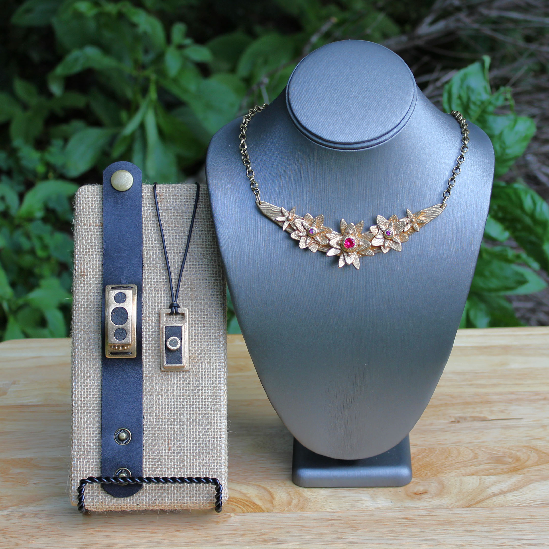 Display Piece featuring Floral Statement Necklace and Men's Pendant/Cuff by Kathryn Designs