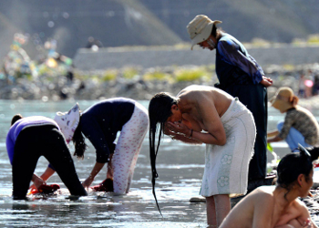 tibetan washing along the river bank