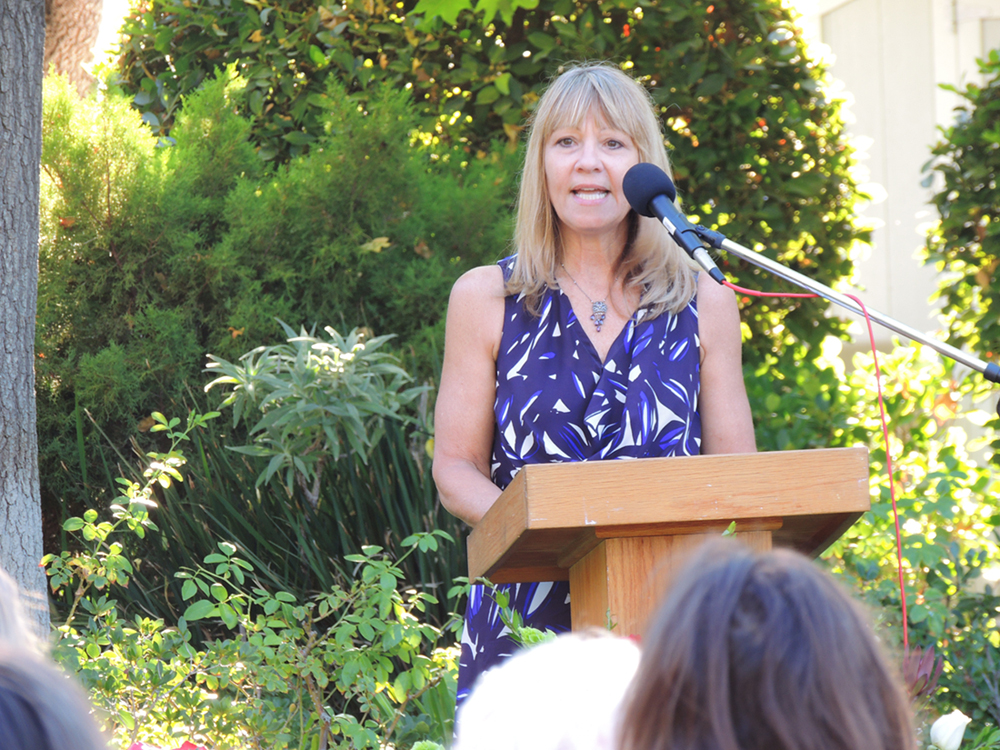 High School English Teacher Karen Grant addresses the community at Highland Hall during their annual Rose Ceremony