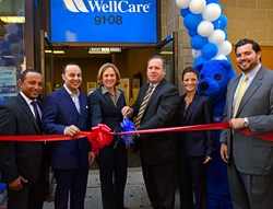 State Assemblyman Francisco Moya and former State Assemblywoman Melinda Katz help John Burke, interim president, WellCare of New York, and other WellCare employees cut the ribbon at the Sept. 20 grand opening of WellCare’s Jackson Heights Welcome Room.