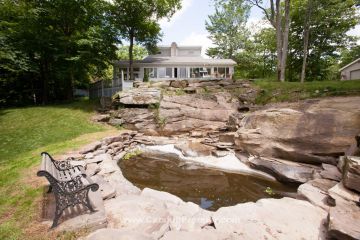 This Catskill Mountain home featuring a 10 foot waterfall with splash pool is offered for $325,000 through Coldwell Banker Timberland Properties. Listing #34240. Call 845-586-3321