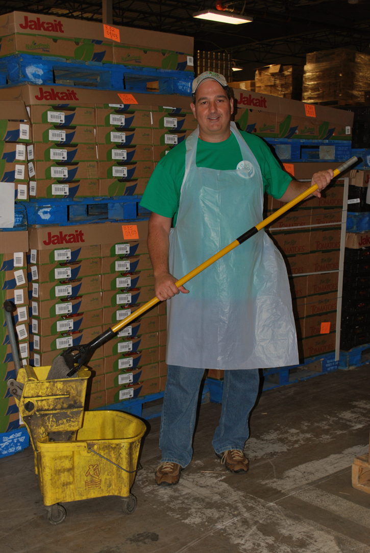 Community Choice President and CEO, Robert Bava, cleans after packaging food at Forgotten Harvest food bank located in Oak Park, Michigan.