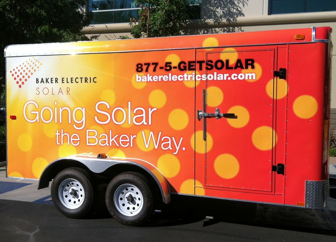 The Baker Electric Solar wrapped trailer serves as a mobile billboard during a solar installation.