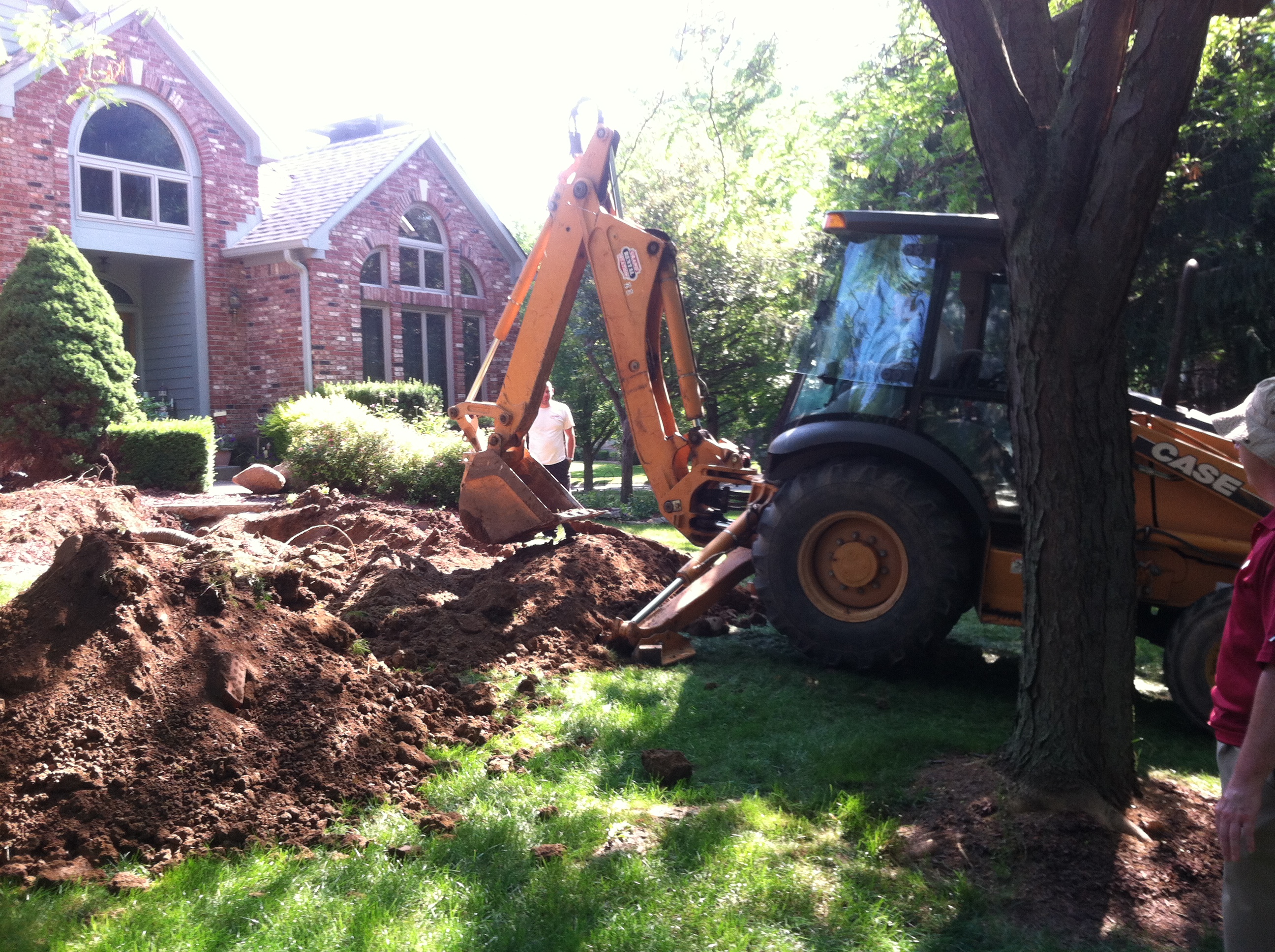 Kelson Carter digs a trench for a sanitary sewer replacement