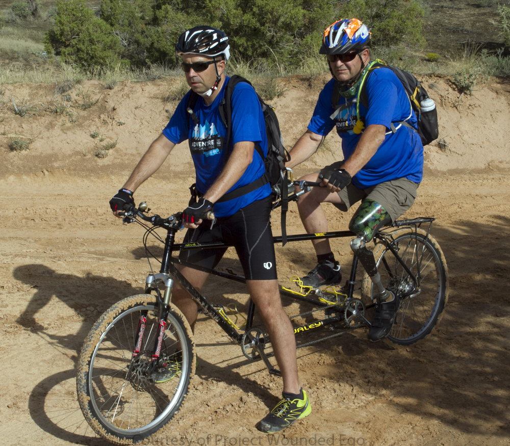 World T.E.A.M. Sports CEO and President Paul Tyler (left) and veteran David Santamore ride a tandem mountain bike at the Adventure TEAM Challenge. Photograph by Brian Gliba, Project Wounded Ego.