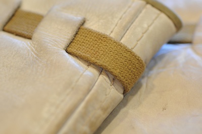 Detailed view of a pair of leather and wool basketball kneepads, circa 1930s.