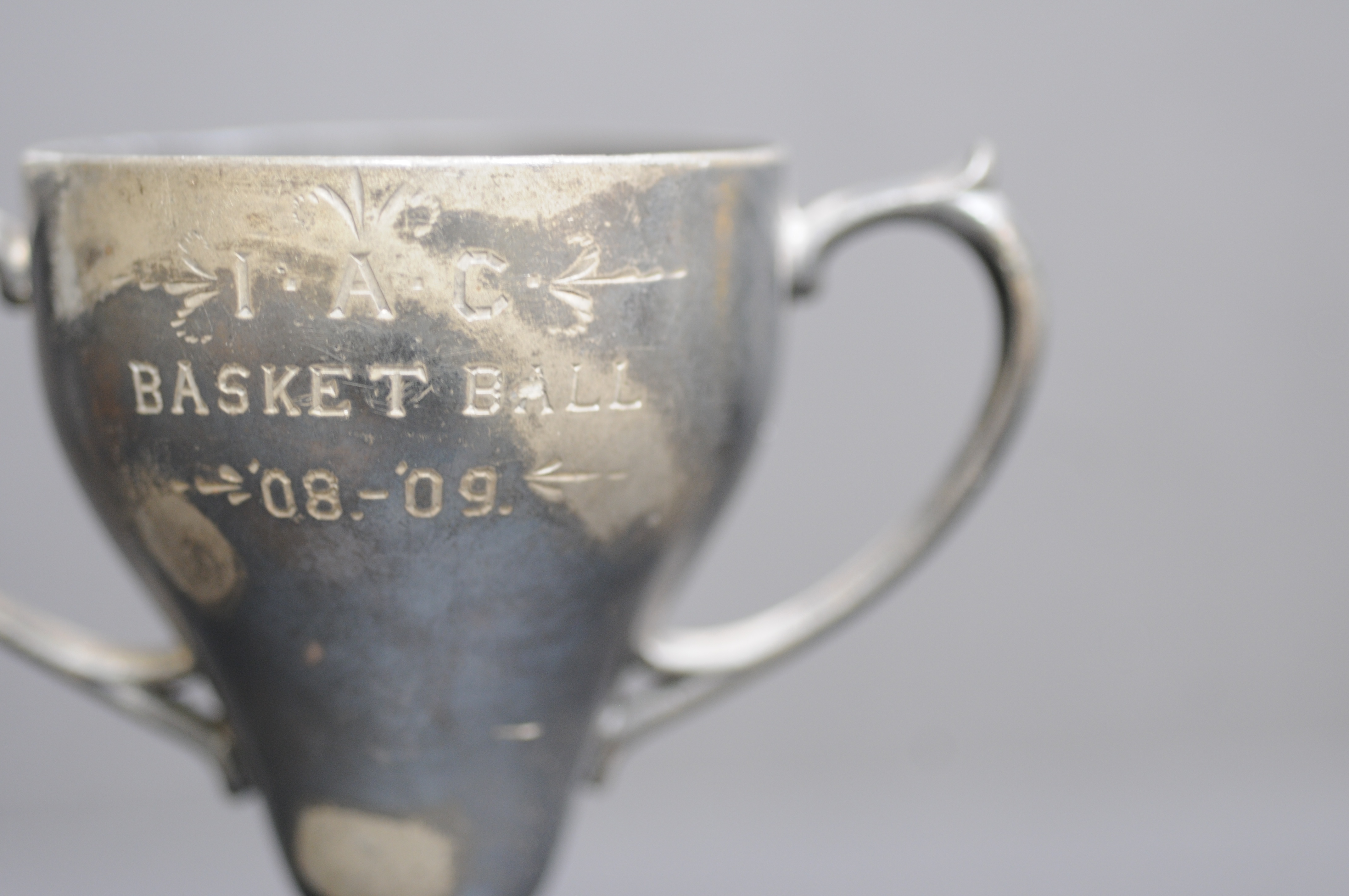 An early example of a silver "loving cup" trophy, awarded in 1909 for excellence in the sport of "basket ball."