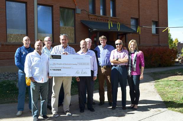 Breckenridge Grand Vacations owners Mike Millisor, Rob Millisor and Mike Dudick present a check  to the People of Summit County for the restoration of the Harris Street school house in Breckenridge.
