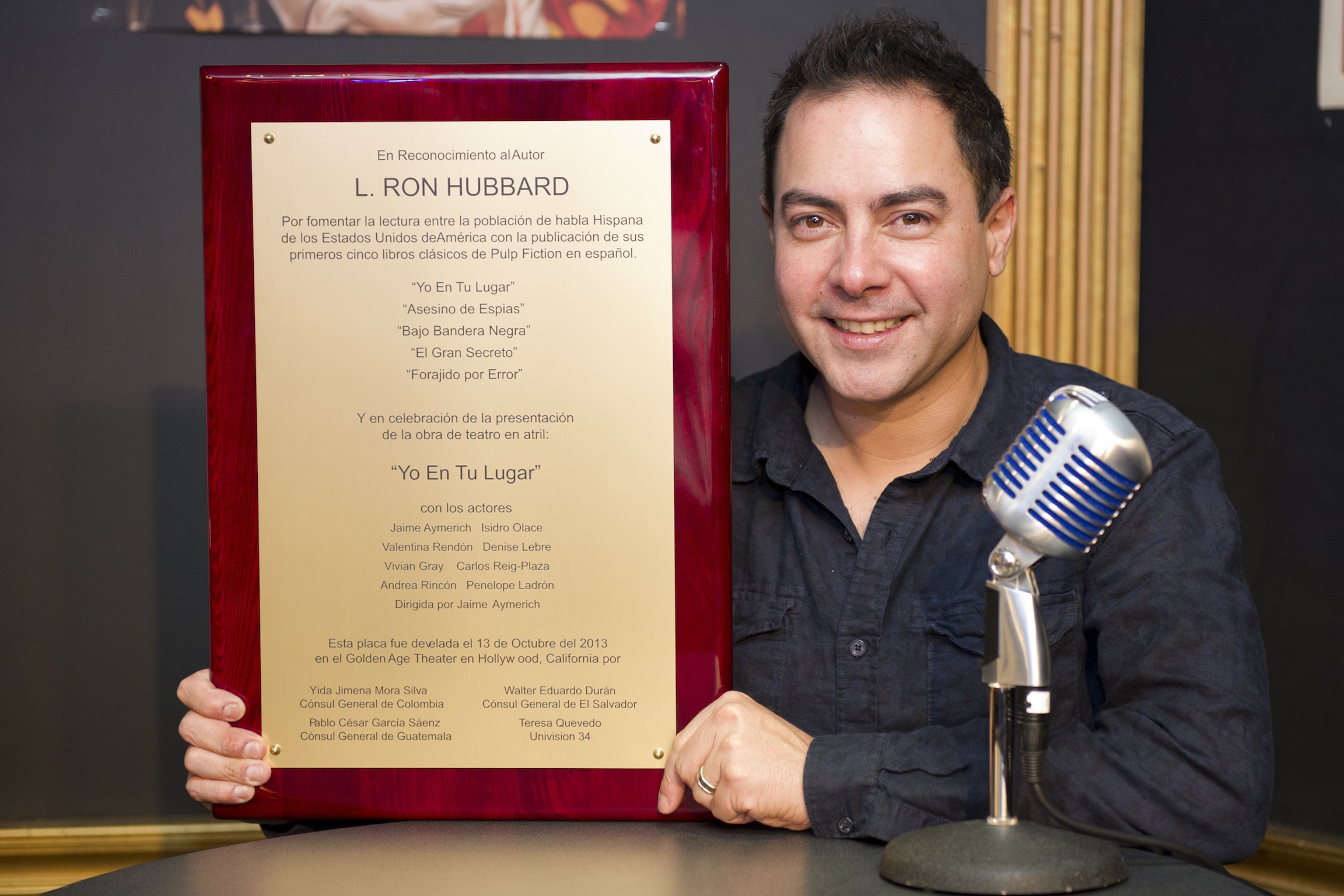 Director Jaime Aymerich with plaque presented to L. Ron Hubbard and actors for superb performance of “If I Were You.”