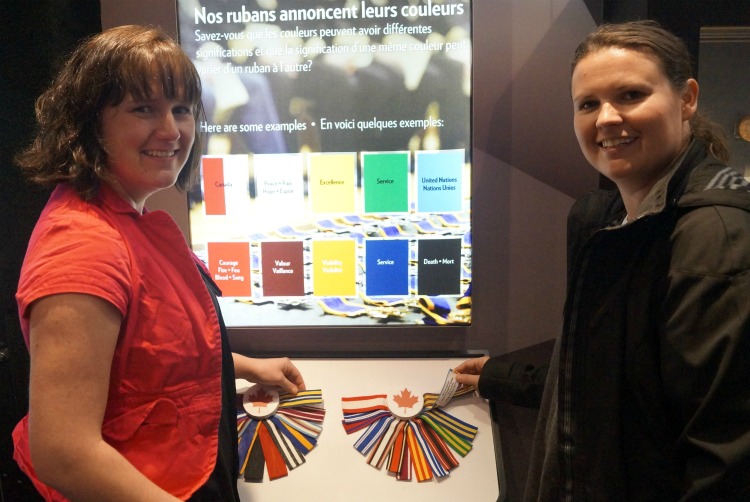Two visitors learn what the different colours of each ribbon represent.