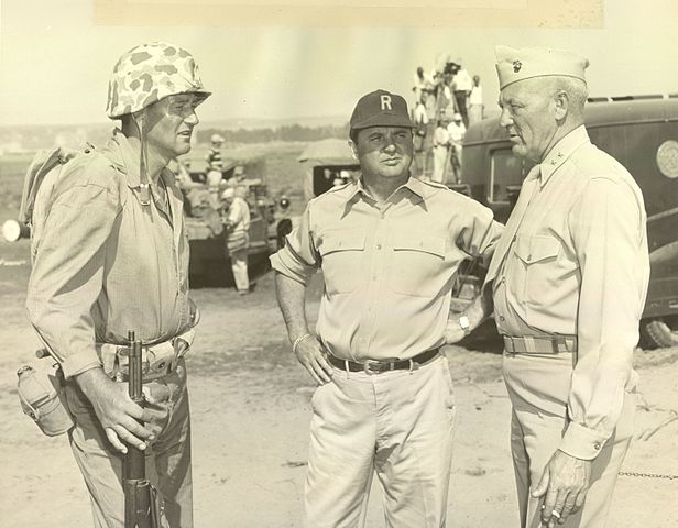Major General Graves B. Erskine, who commanded the 3rd Marine Division on Iwo Jima, talks with John Wayne on the set of SANDS OF IWO JIMA in 1949. USMC PHOTO