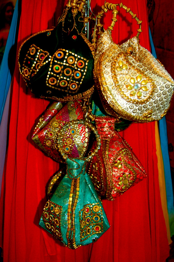 These jeweled silk bags from India hang at one of many booths displaying fashion and gift items from around the world from