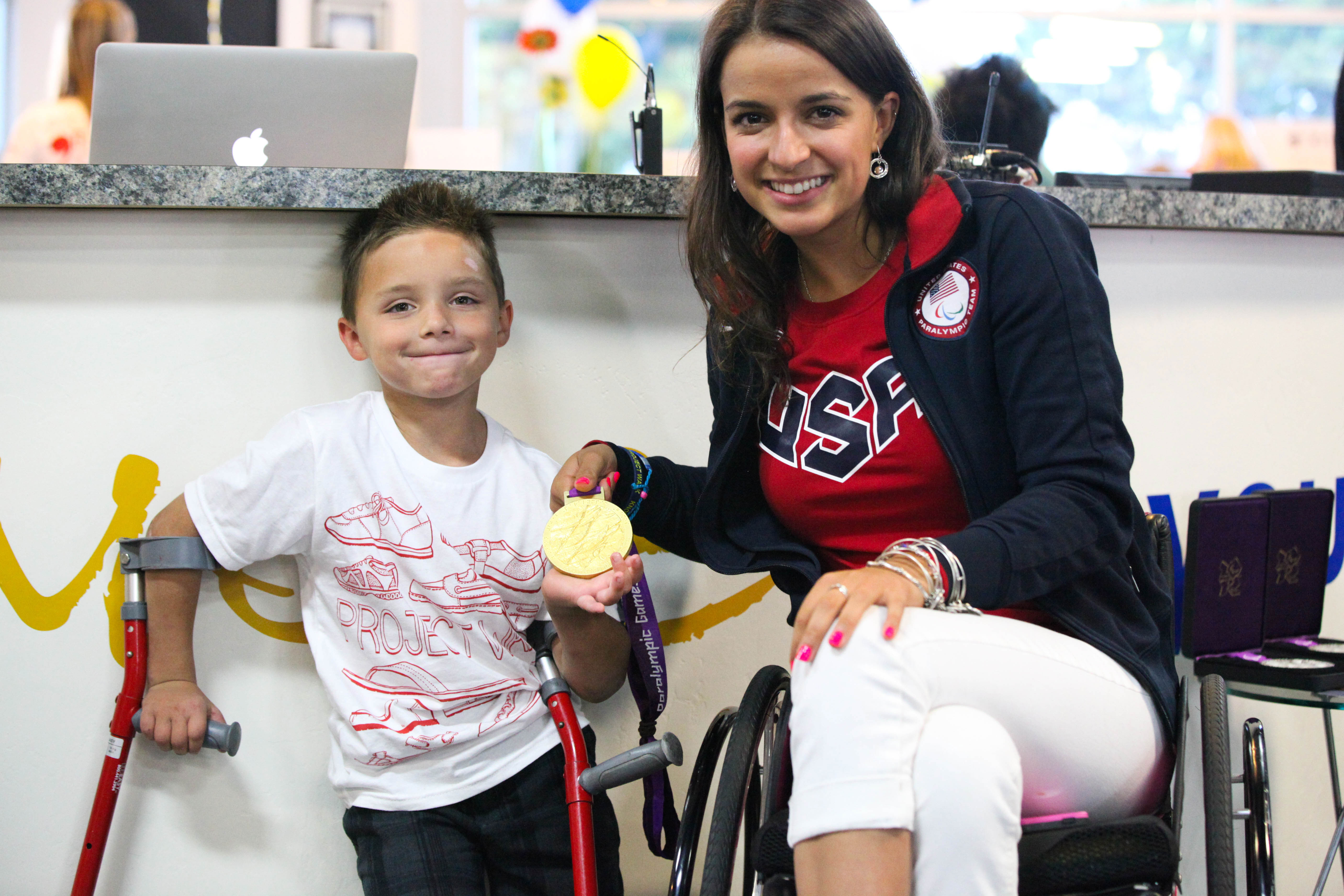 Gold Medalist and Paralympian, Victoria Arlen takes time to greet Project Walk client, Jonathan Williams (7) at the 9th Annual Steps to Recovery Event.