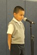 Kindergartener, Jean-Eduard, recites "Color Me Happy!" at the Everst Academy Annual Poetry Contest