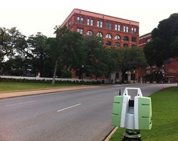 The Leica ScanStation in Dealey Plaza, the location of President John F. Kennedy’s assassination. The sixth floor corner window of the Texas School Book Depository (now a museum) is visible just above the tree line.
