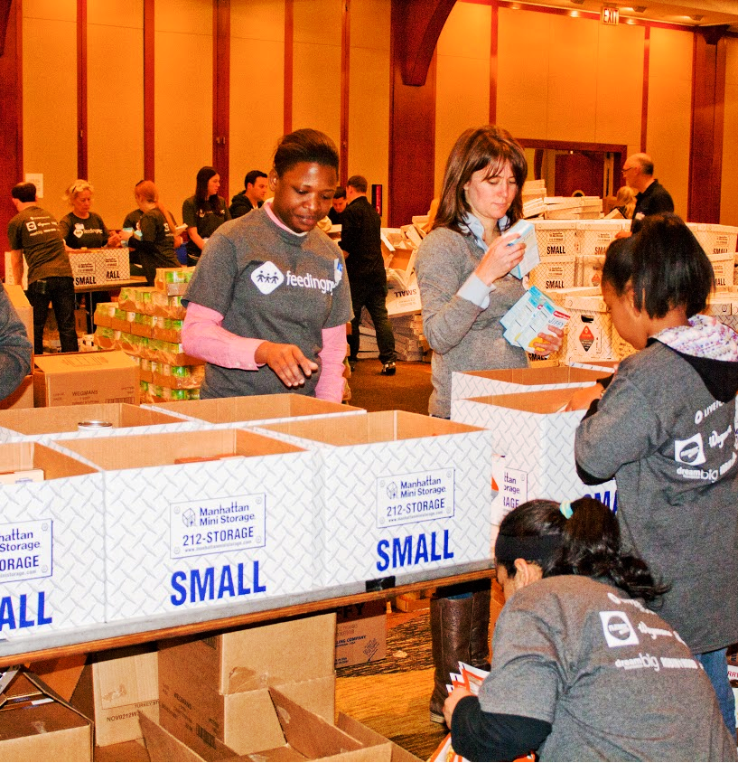Volunteers fill Manhattan Mini Storage boxes with Thanksgiving dinners for the needy at the annual FeedingNYC event.