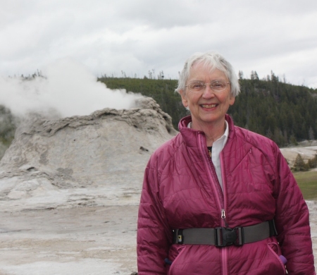 Janet Chapple in front of Castle Geyser, Yellowstone National Park
