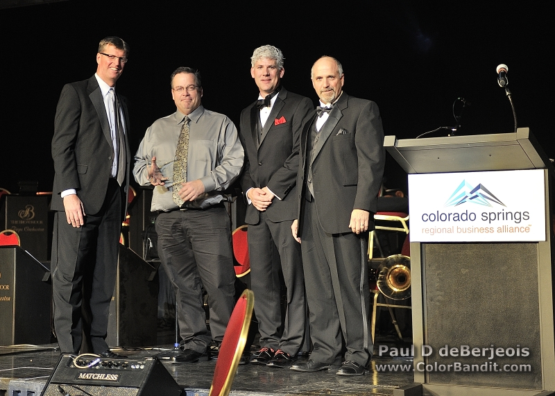 Patrick Bollar, DMS CEO accepts the Colorado Springs Regional Business Alliance 2013 Excellence in Manufacturing Award