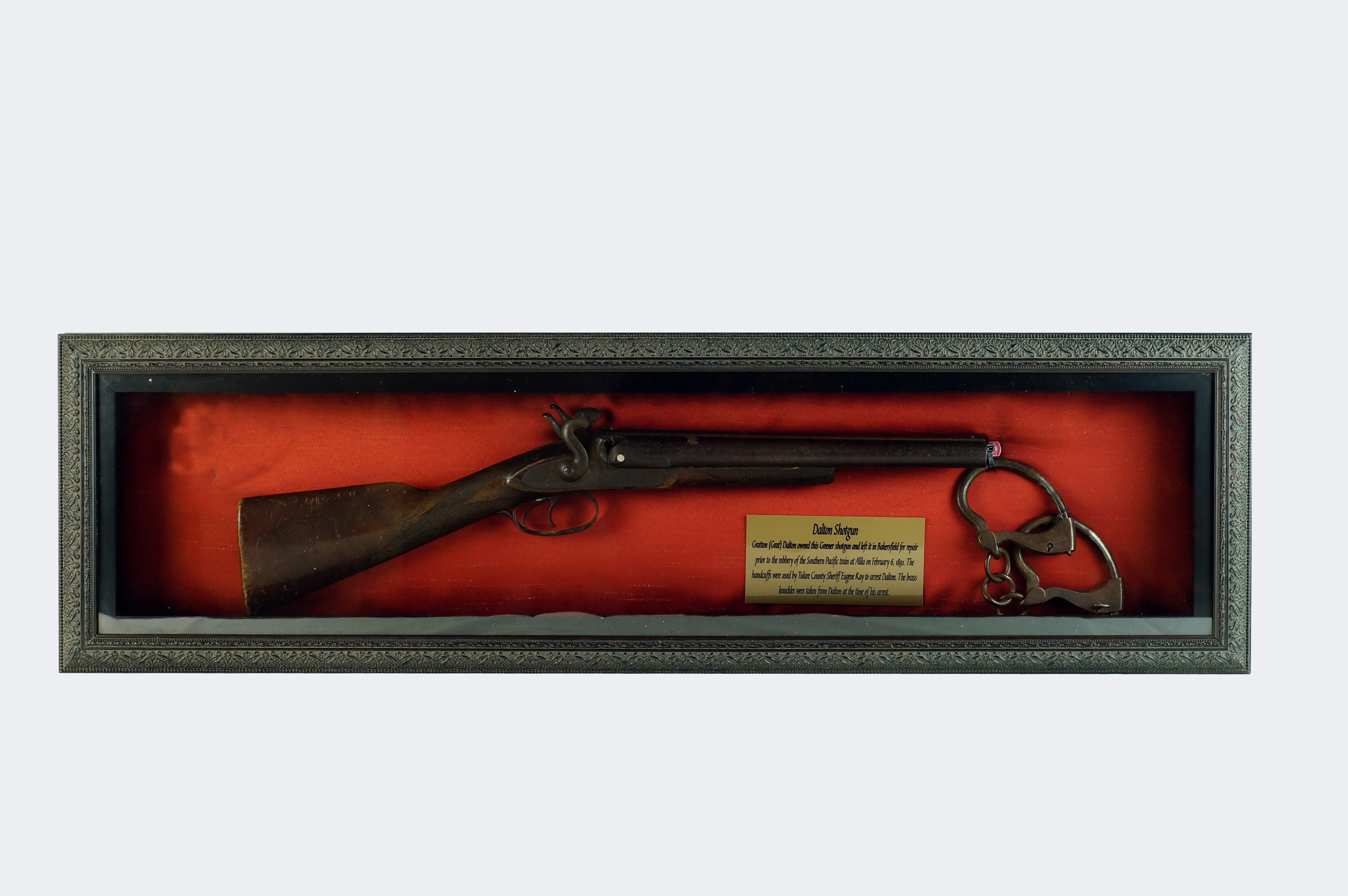 Grat's Shotgun shown in it's shadowbox and lot 200a, the Sheriff Eugene Kay Handcuff's used to arrest both Grat and Bill Dalton in 1891