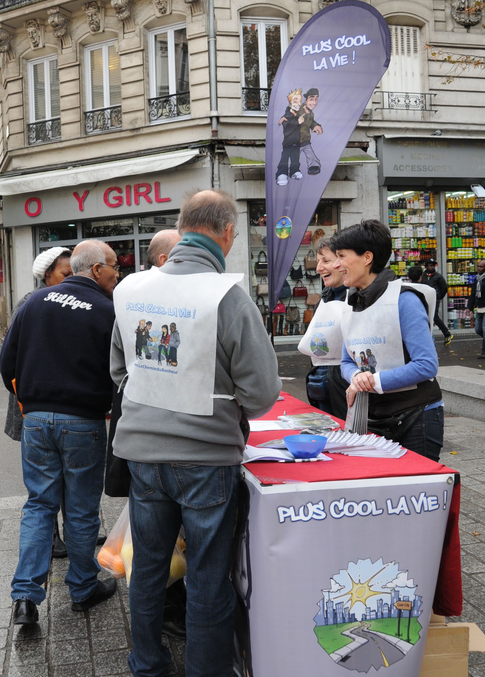 Volunteers from Scientology Churches of Paris share the message that life is “much cooler” when it is moral, at The Way to Happiness booth November 2, 2013, in the Paris suburb of St. Denis.