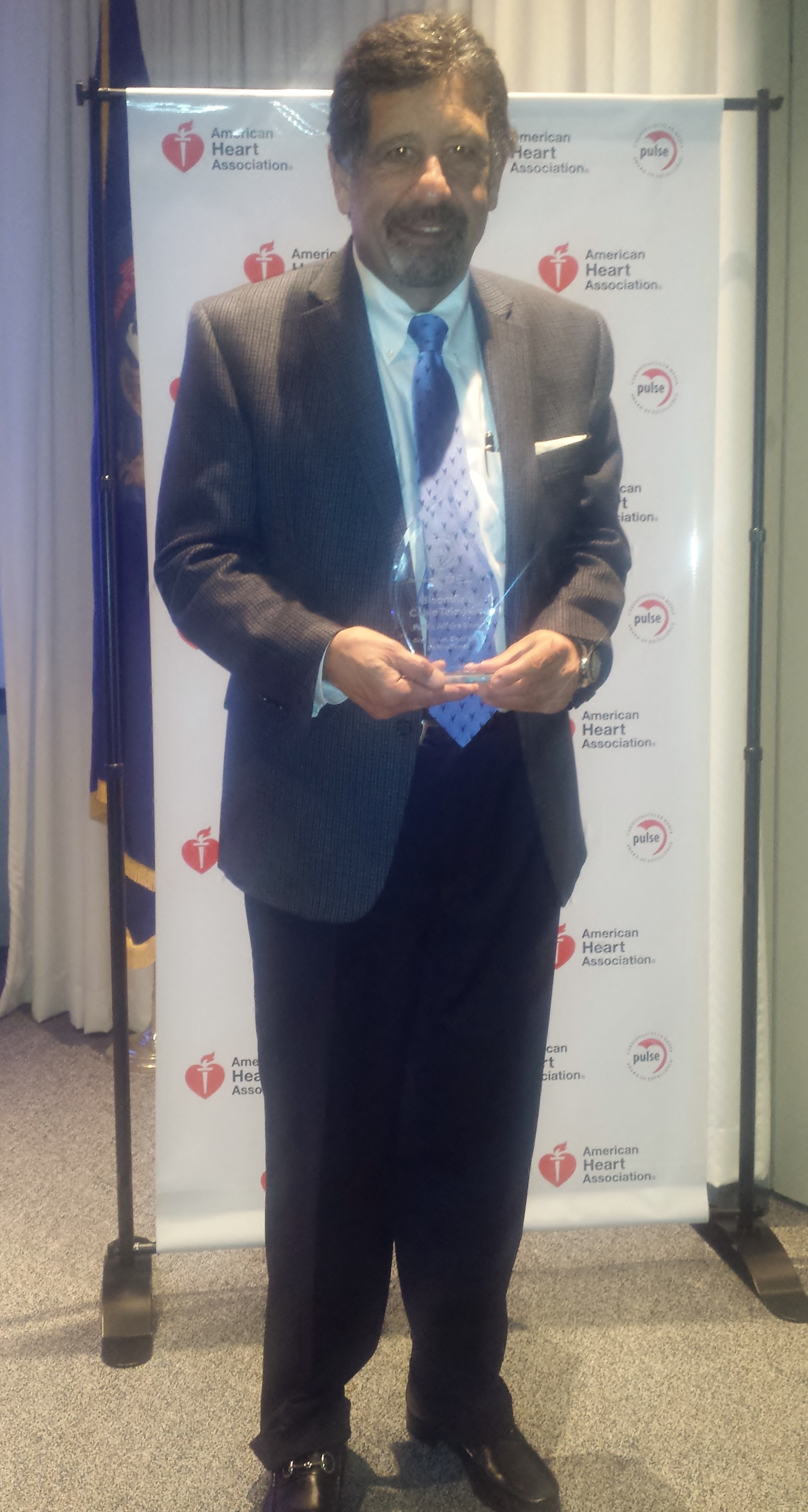 Gregory Jamian, producer and host of "Senior Matters", poses with his Pulse Award