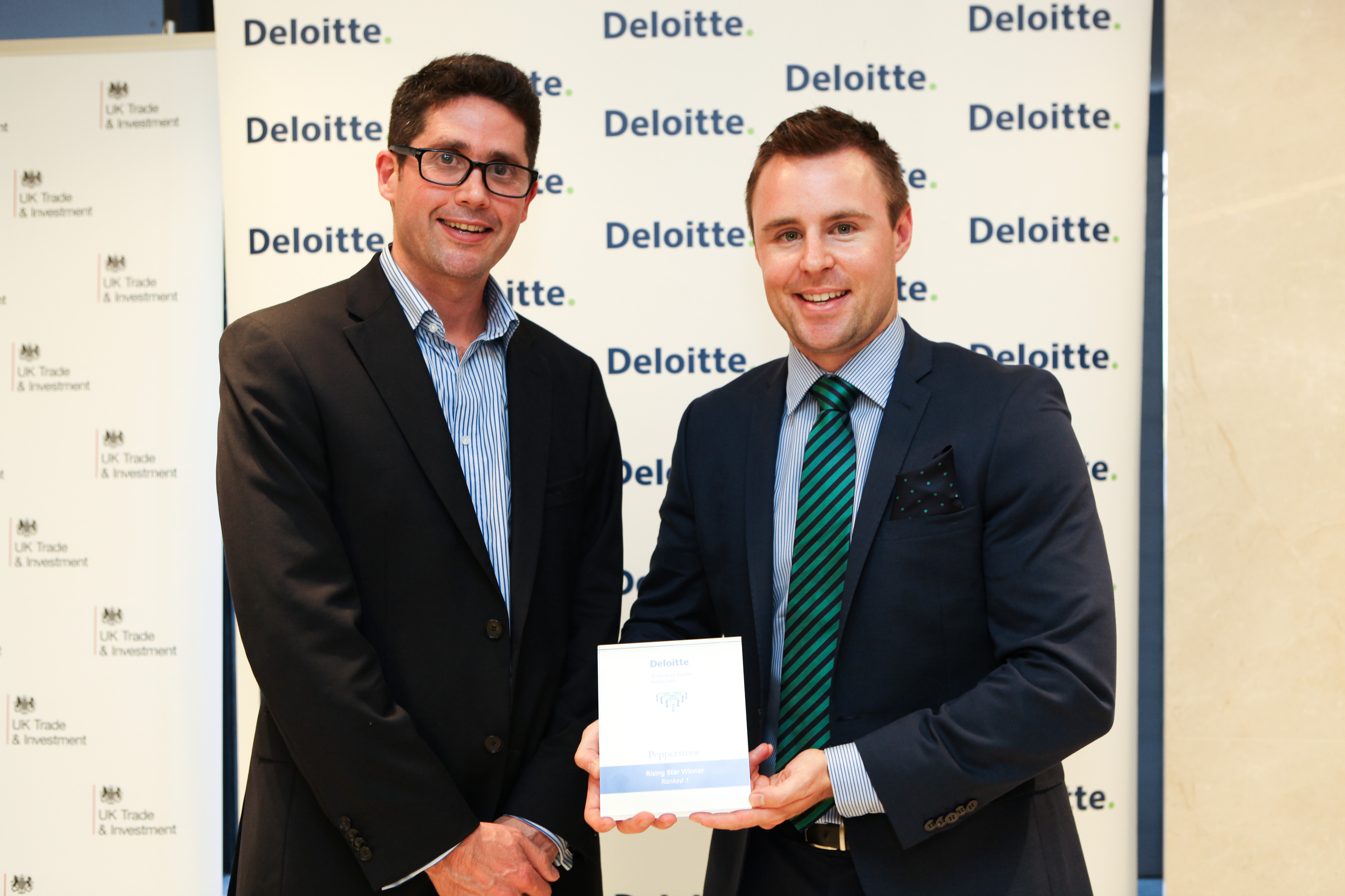 Pepperstone CEO Owen Kerr collecting the Award from Deloitte