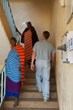Dr. Kleeman, right, walks up stairs past Maasai tribesmen. (Ron Ashley Photo)