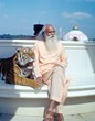 Swami Satchidananda seated with a tiger at the Satchidananda Ashram-Yogaville, in Buckingham, Virginia