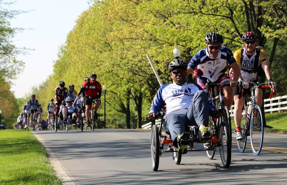 LeMar Best rides a recumbent bicycle on the first day of the 2013 Face of America ride. Photograph by Kimberly Warpinski.