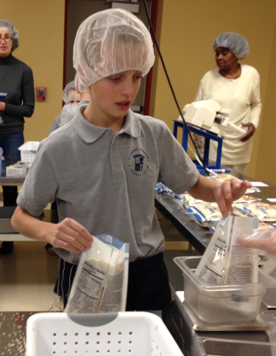 John Beecher, a 4th grader at Everest Academy, puts faith into action at "Feed My Starving Children" in Aurora, helping to stop hunger one meal at a time.