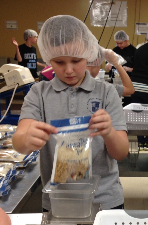 An Everest student helps package food at "Feed My Starving Children" in Aurora, IL.