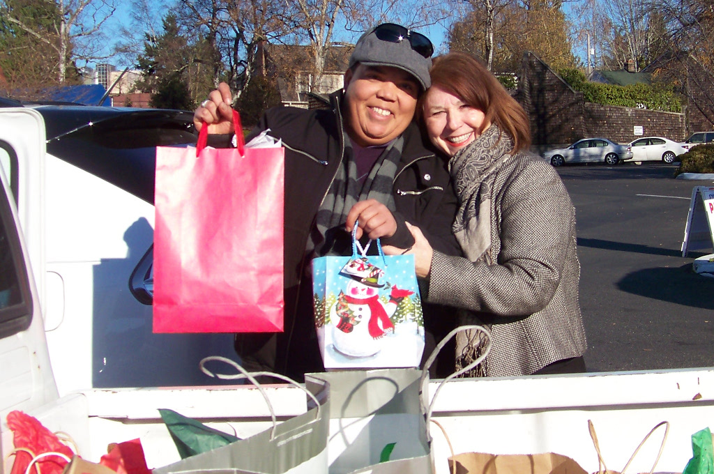 Rochelle Calkins of the Seattle YWCA and Claudia Smith with Christmas donations.