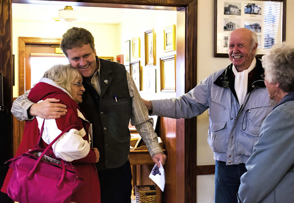 Retired Mayor Sandra Bigler and newly elected Mayor Dave Blackham share a friendly hug at museum opening.
