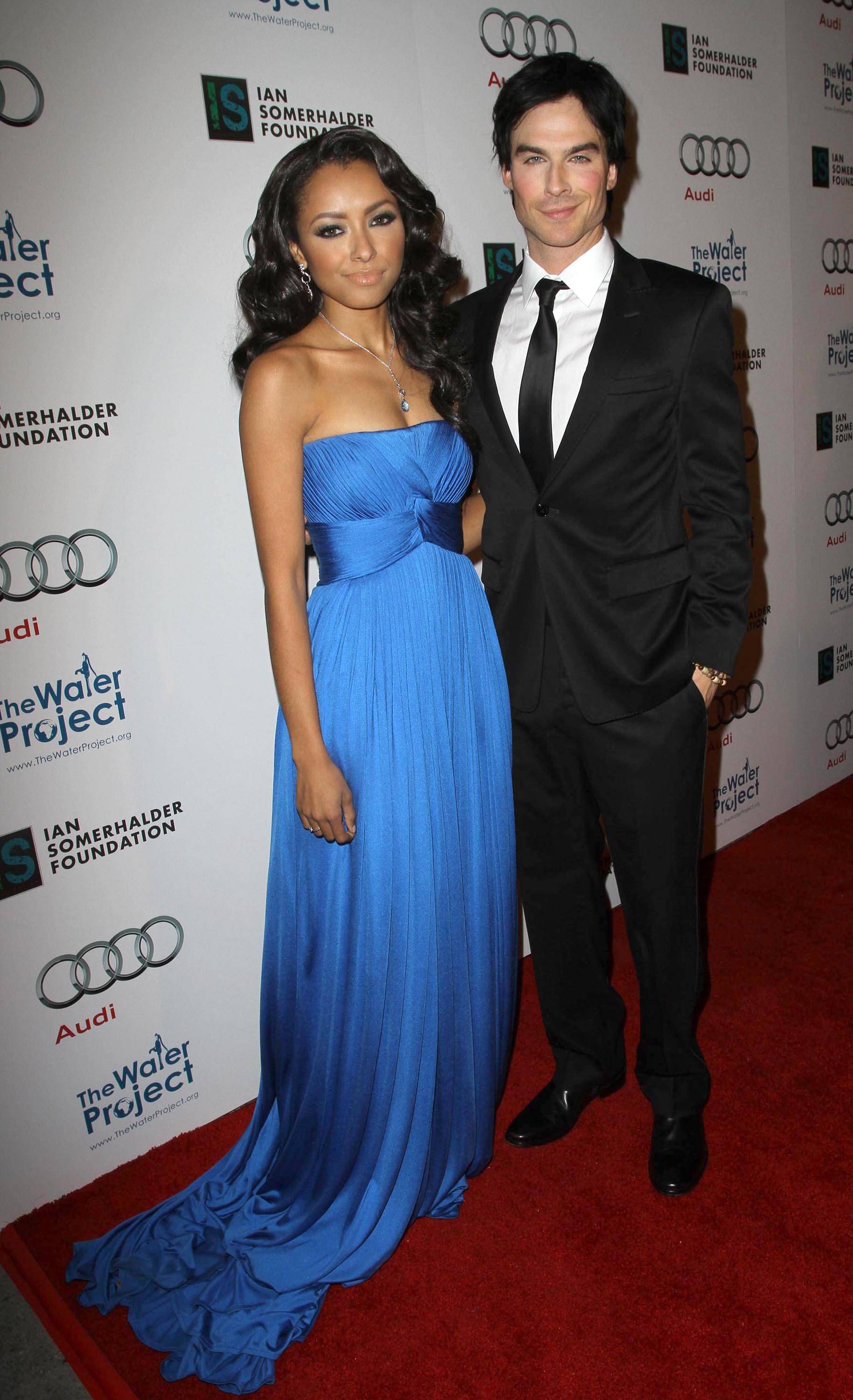 Kat Graham wearing a Lloyd Klein strapless gown attending a benefit for the Water Project