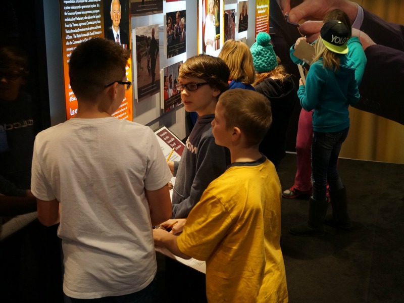 Students at Pioneer Middle School learn about the Canadian Honours System through interactive displays in the exhibit.