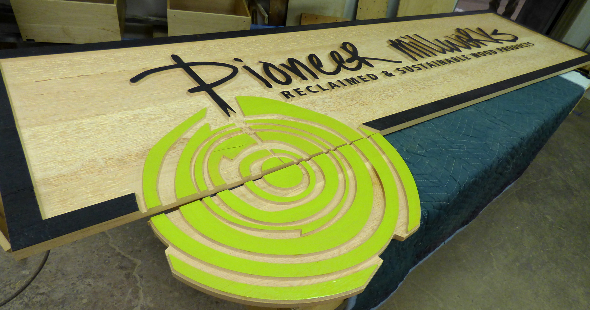 Pioneer Millworks west coast showroom sign is a perfect example of the work they can do using varied carving textures and detailed cutting to create a crisp and modern look with the CNC tool.