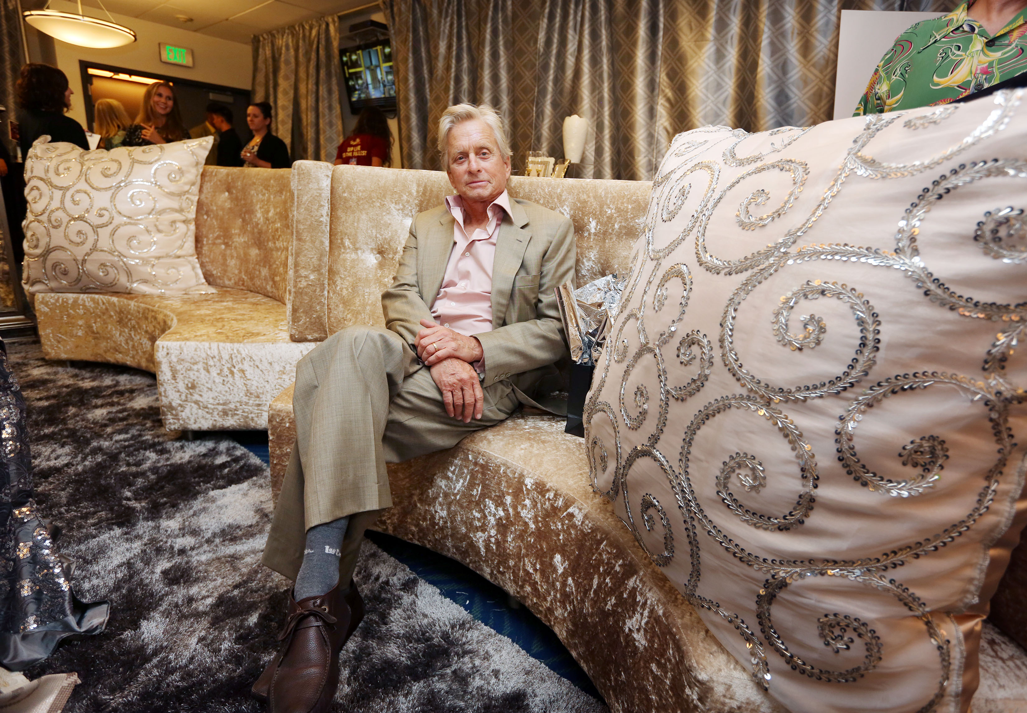 Sitting on shades of gold, Michael Douglas relaxes on one of Lux Lounge EFR's custom made luxurious furniture designs