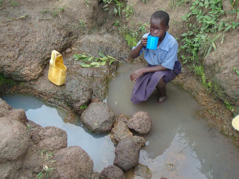 A child takes a break from the three mile walk and drinks contaminated water at the local watering hole, only to realize he’s got a three mile walk home.