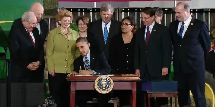 President Obama signs the Agricultural Act of 2014 in Lansing, Michigan.