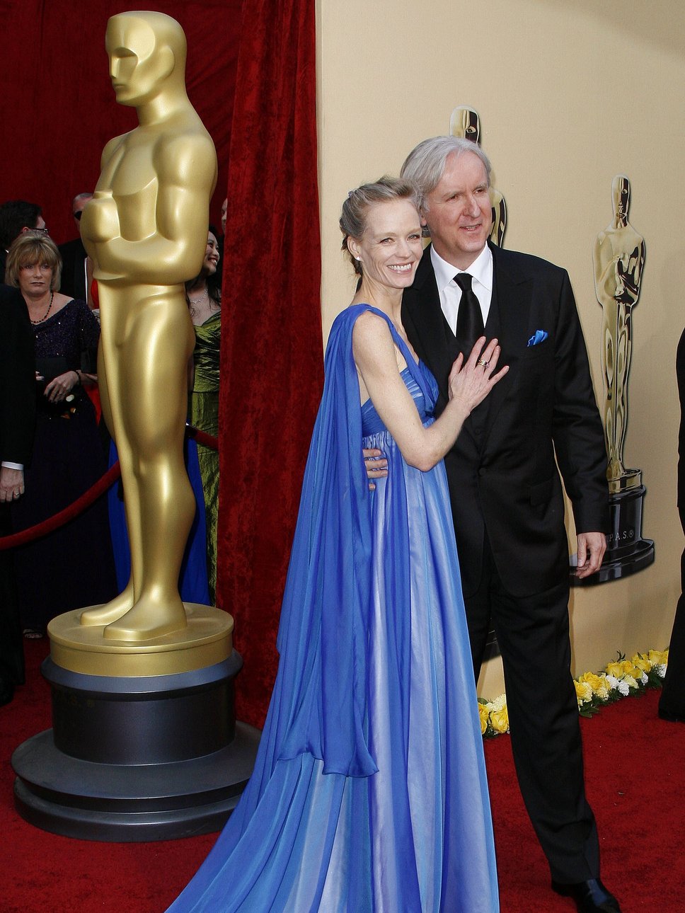 Suzy and James Cameron at the Oscars in the very first gown from Red Carpet Green Dress